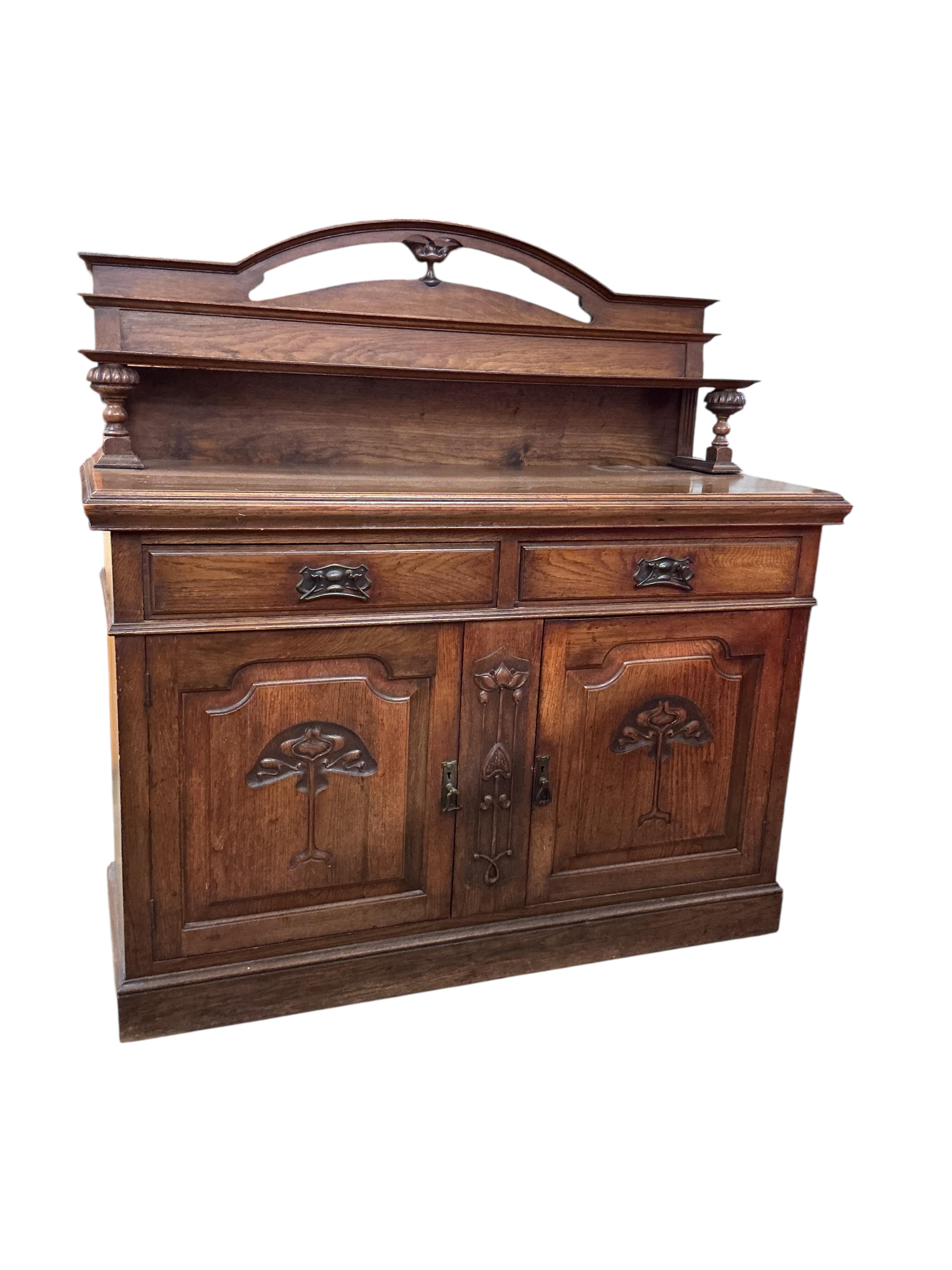 A late Victorian Art Nouveau oak sideboard, width 137cm, depth 54cm, height 140cm